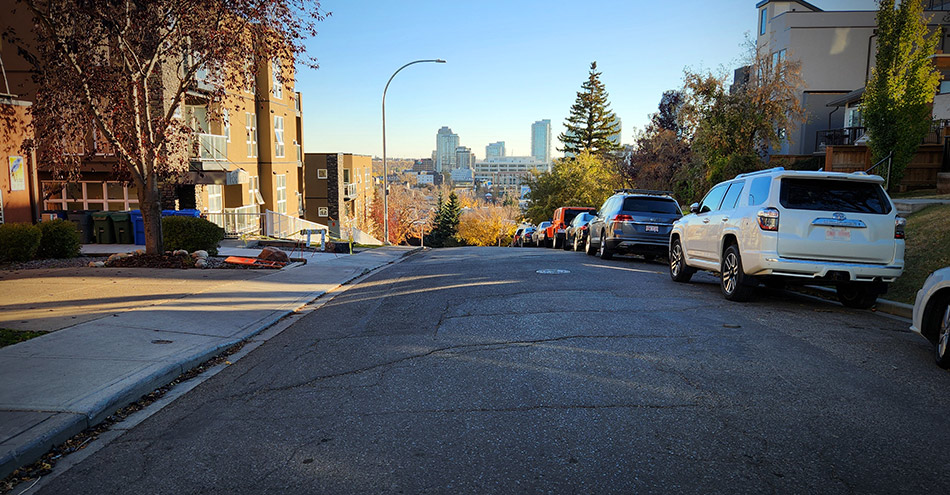 A city road as it opens to the view of a valley